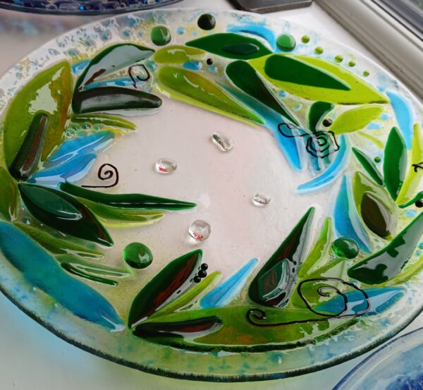 Fused glass dish in greens (peacock tail style)